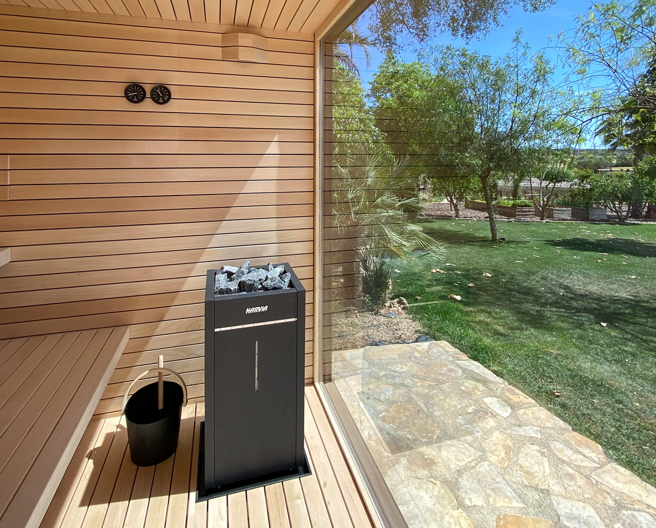 Garden sauna with integrated sauna stove and design benches