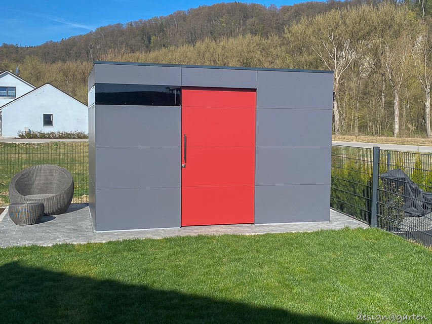 Stylish tool shed with flat roof as a colourful statement in the garden