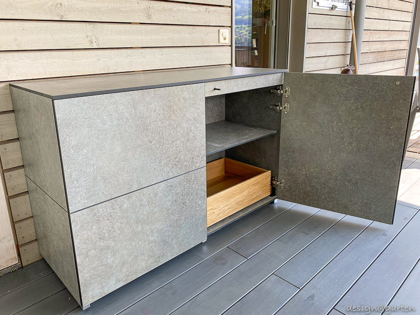 Small weatherproof patio cabinet as a sideboard with a view of Lake Thun