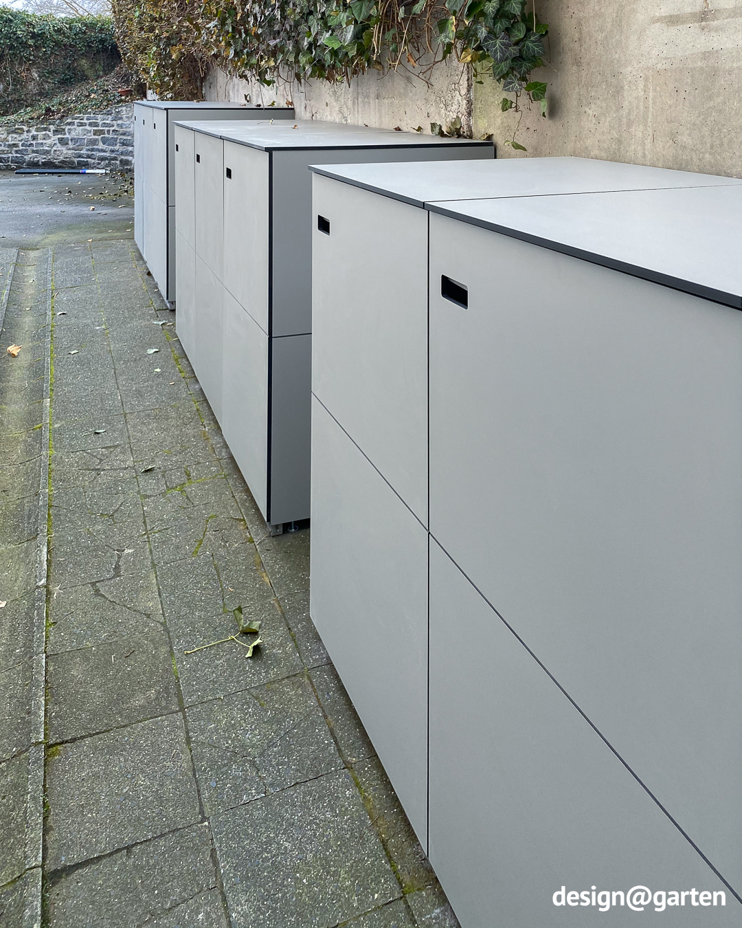 Three 3-bin waste bin enclosures in light grey made of HPL 2