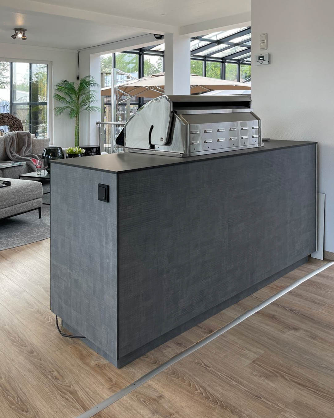 Small, grey outdoor kitchen with built-in Napoleon barbecue 2