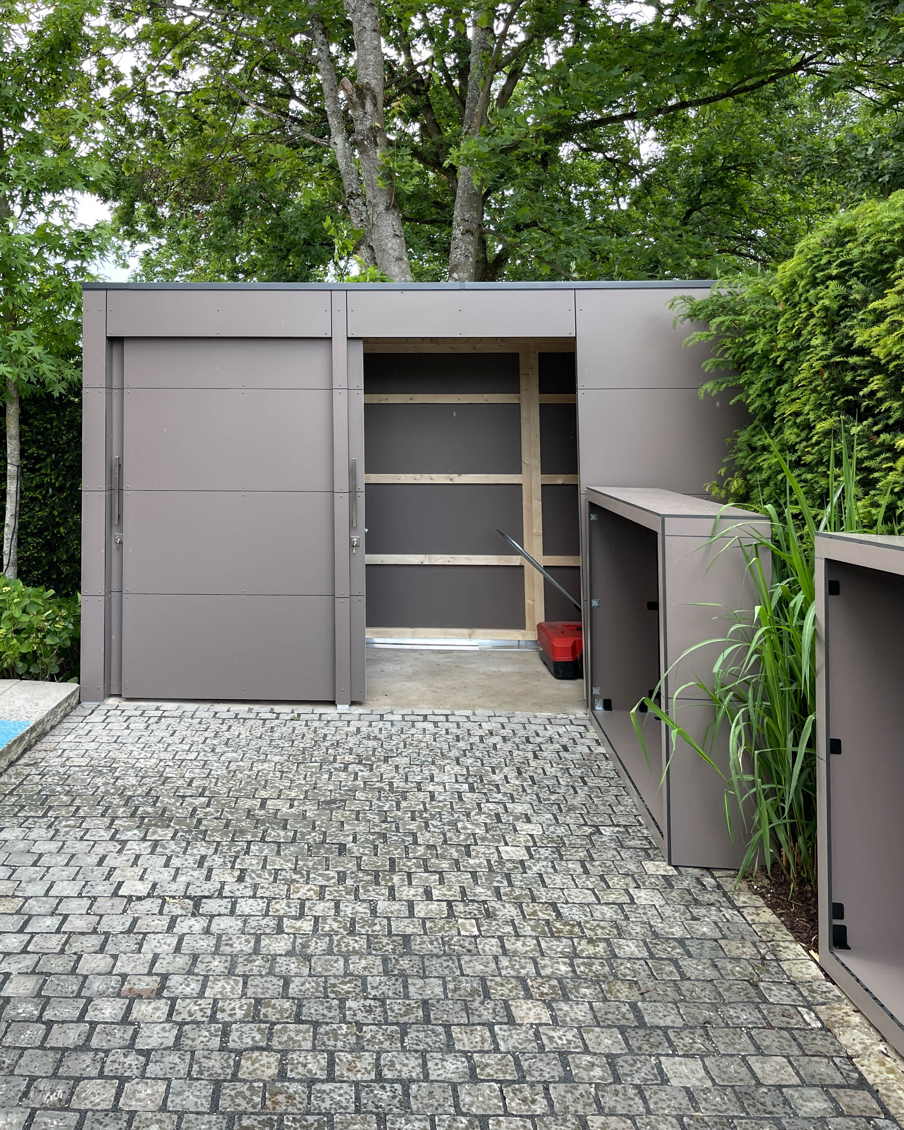 A perfect trio: wood storage, garden shed and bin storage unit 2