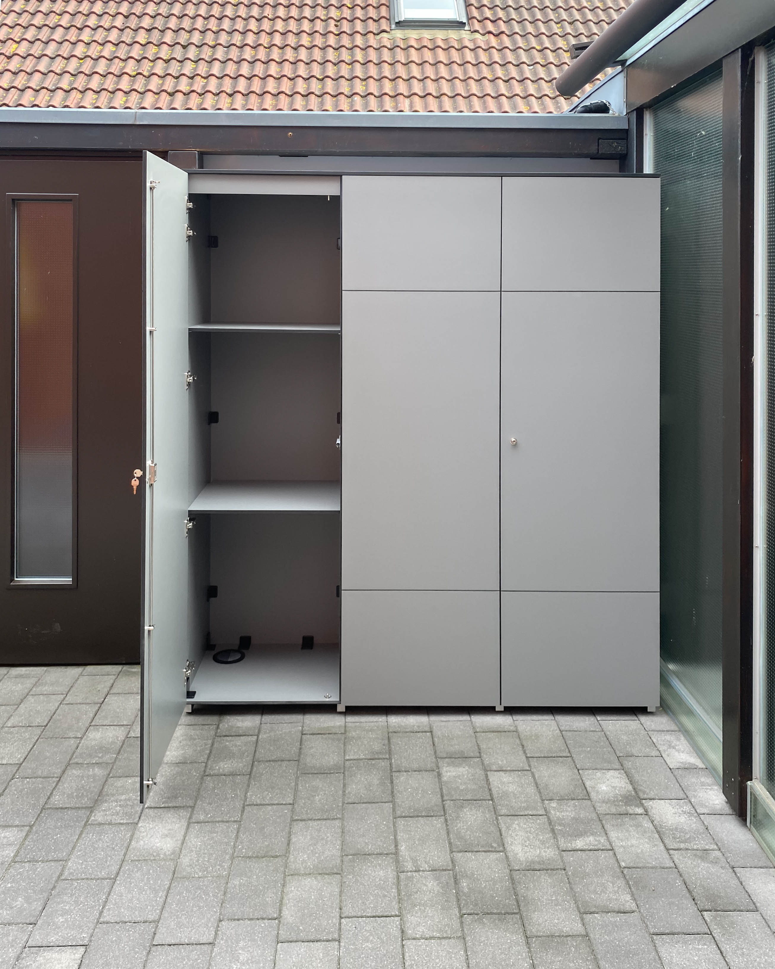 Großer Outdoorschrank mit geöffneter Türe und sichtbaren Einlegeböden